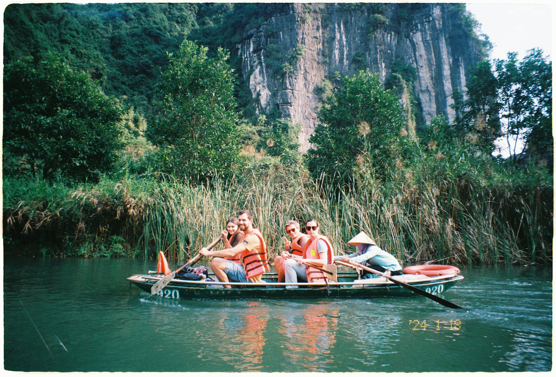 A group of people riding on the back of a boat